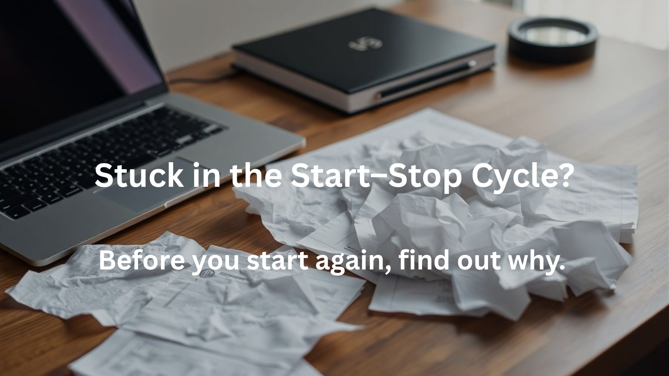 Crumpled plans beside a laptop representing the start-stop cycle in online business